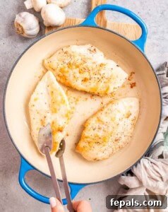 Golden Pan-Seared Chicken Medallions 11 Cooking chicken breasts in a skillet.
