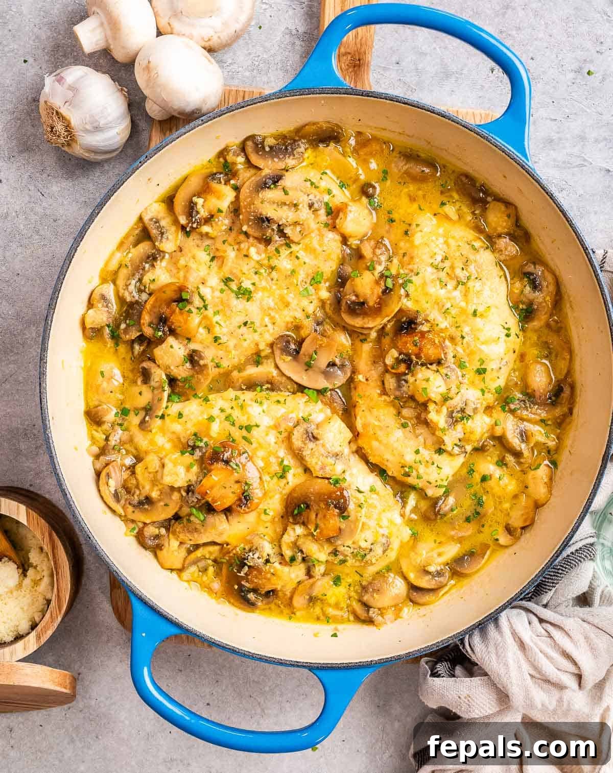 Golden Pan-Seared Chicken Medallions 7 Chicken scallopini in a blue skillet.
