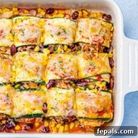 Effortless Cinco De Mayo Feast 12 top view enchilada roll ups with zucchini and topped with melted cheddar cheese
