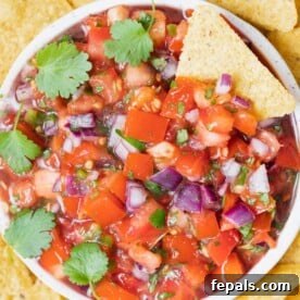 Effortless Cinco De Mayo Feast 15 a round bowl with pico de galo salsa and tortilla chips around it.