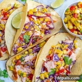 Effortless Cinco De Mayo Feast 5 top view of Salmon Tacos With Corn Salsa side by side on a plate