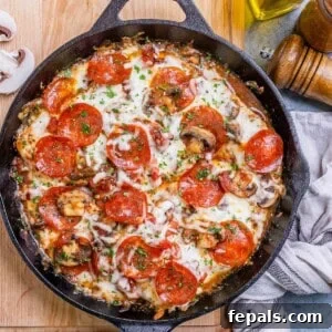 pizza looking seared and baked chicken breasts in a skillet.