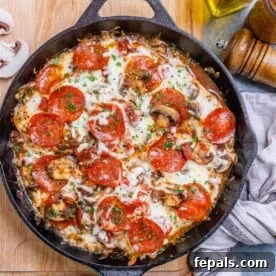 pizza looking seared and baked chicken breasts in a skillet.