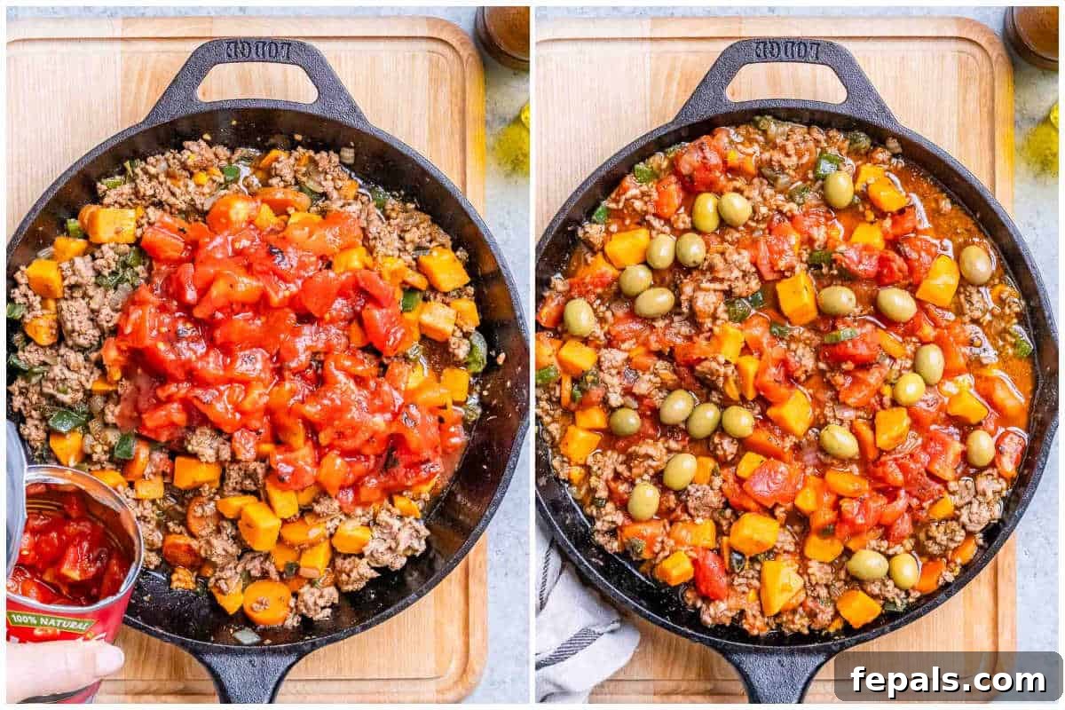 Hearty Mexican Picadillo 5 A process shot showing browned ground beef and sautéed vegetables in a skillet, with diced tomatoes being added next.