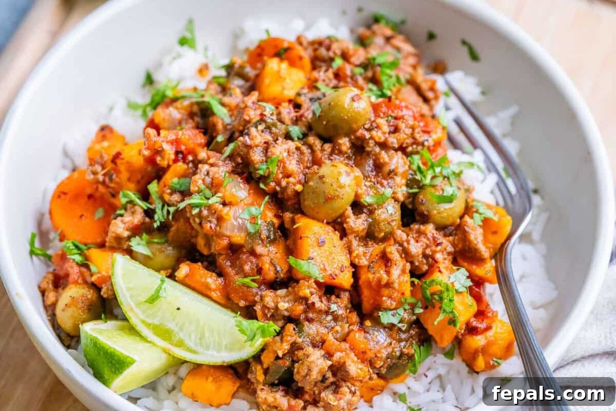 Hearty Mexican Picadillo 7 A beautiful bowl of Mexican picadillo served over fluffy white rice, ready to be enjoyed.