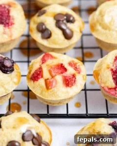 mini pancake muffins on a wire rack, topped with maple syrup.