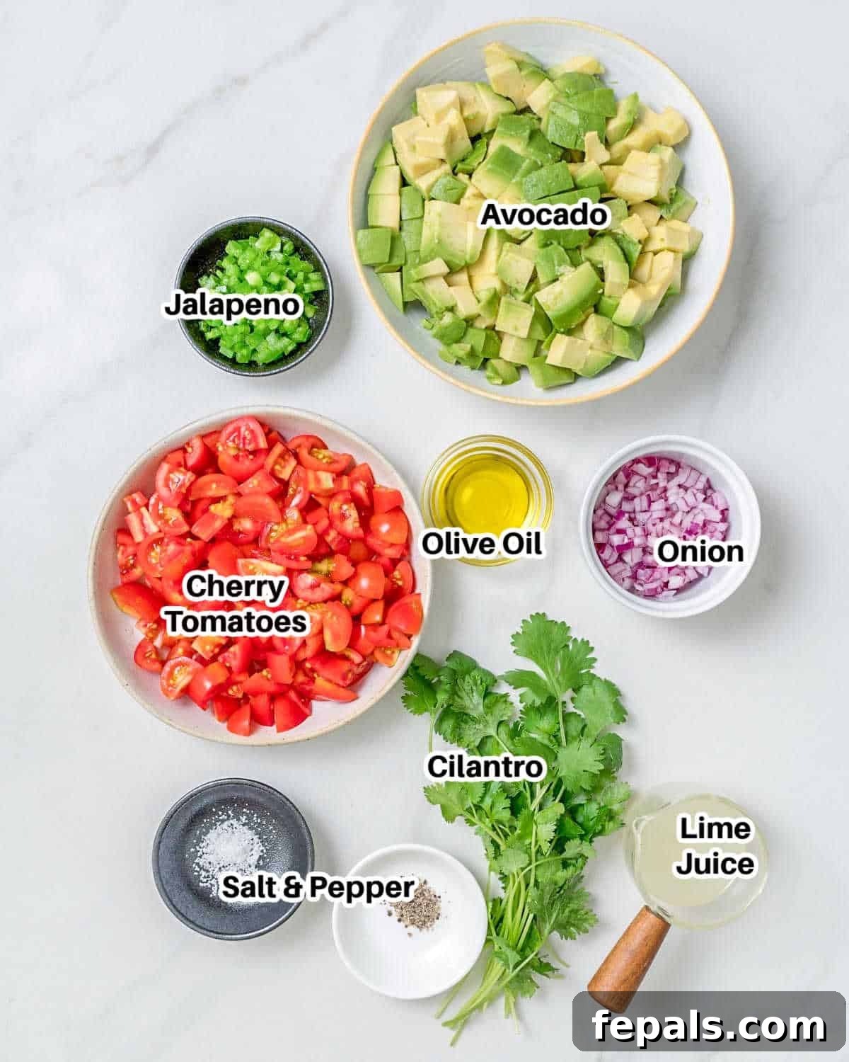 A spread of fresh ingredients laid out on a surface, ready to be prepared for the avocado salsa.