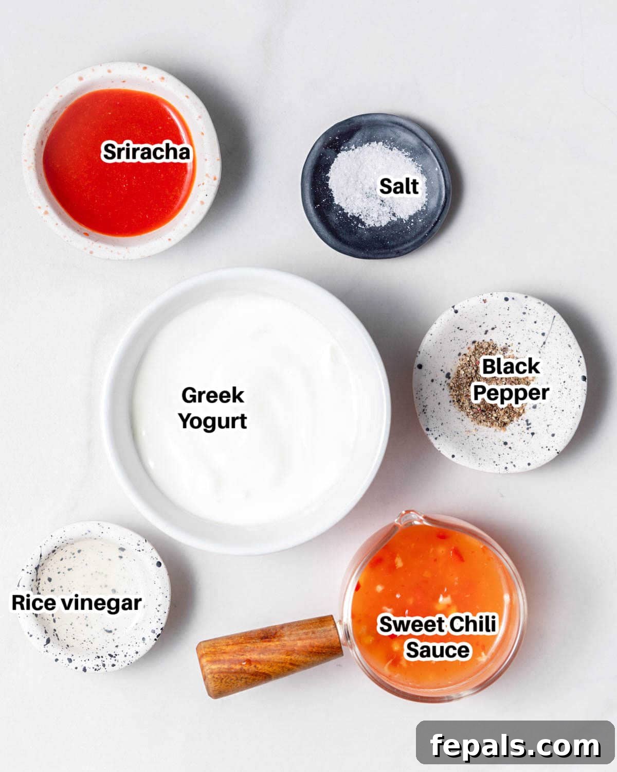 Irresistible Bang Bang Sauce 3 All the necessary ingredients laid out for making Bang Bang Sauce, including Greek yogurt, chili sauce, and sriracha.