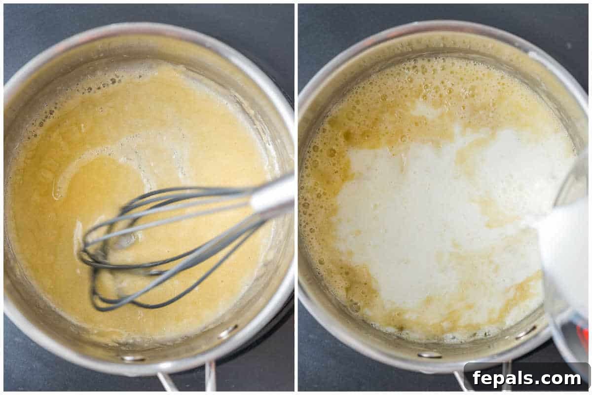 Warm milk being slowly poured into the butter and flour roux in a pan, as part of the Bechamel sauce preparation process.