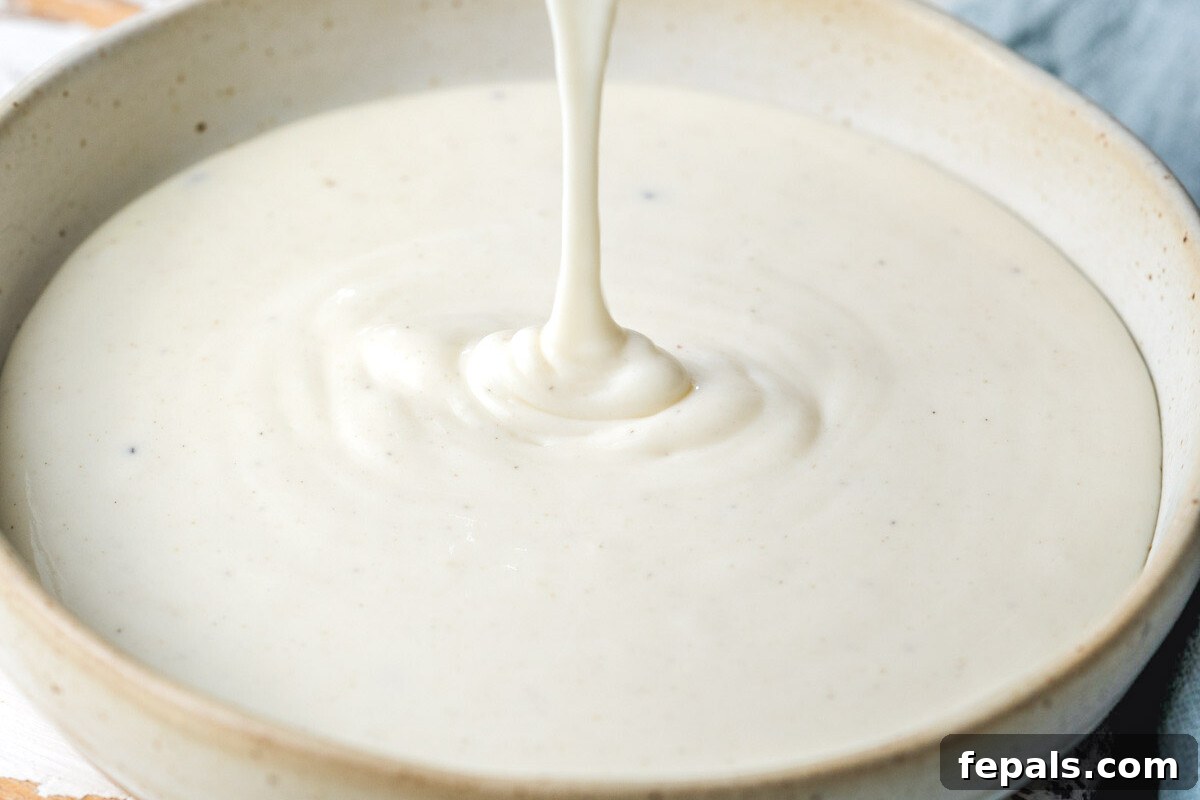 A beautiful bowl of Bechamel sauce ready to be served or used in a recipe, highlighting its creamy texture.
