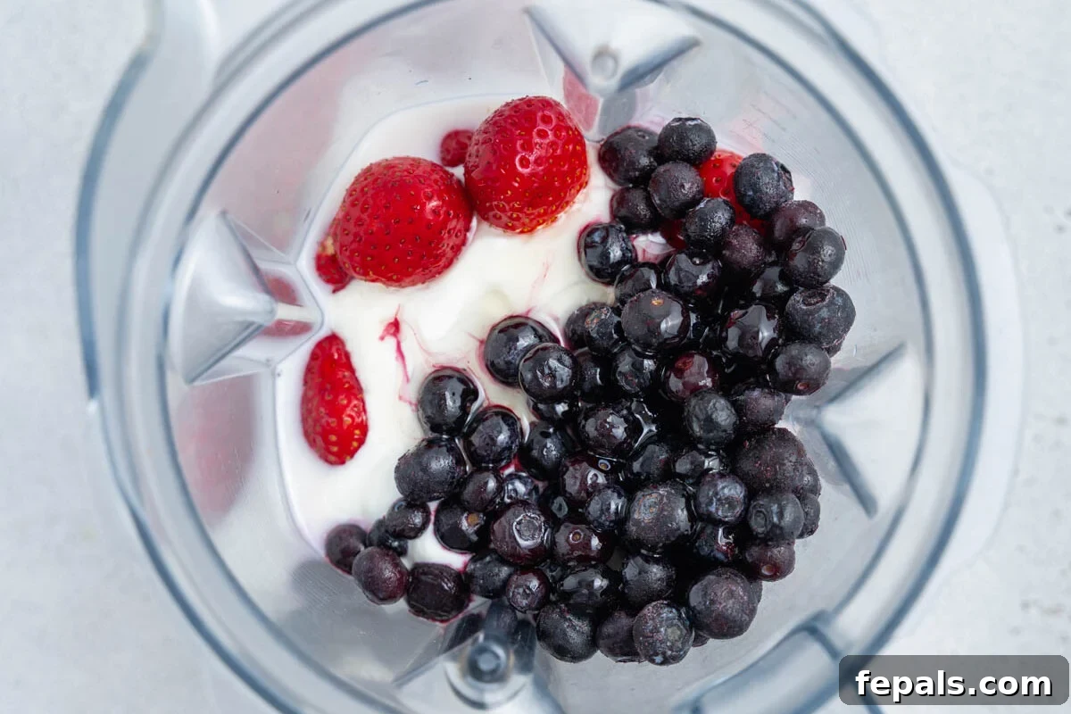 Creamy Strawberry Blueberry Smoothie with Greek Yogurt 5 berries, yogurt, and all other smoothie ingredients added to a blender.