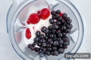 Creamy Strawberry Blueberry Smoothie with Greek Yogurt 10 berries, yogurt, and all other smoothie ingredients added to a blender.