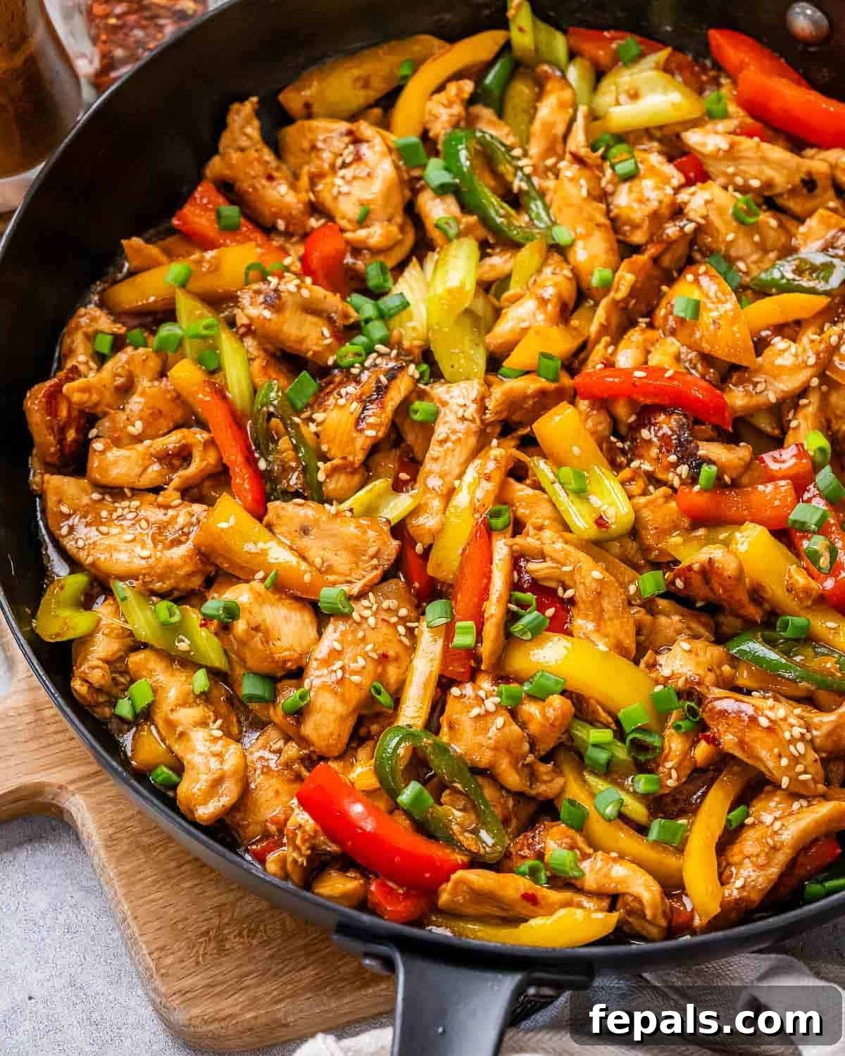Authentic Hunan Chicken Recipe: Spicy Stir-Fry with Peppers 2 A wok with Hunan chicken, celery and bell peppers.