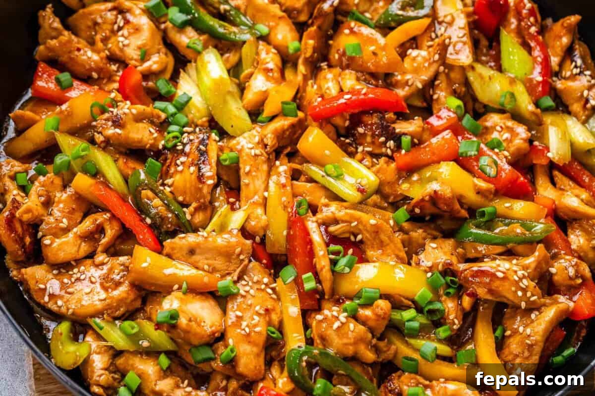 Authentic Hunan Chicken Recipe: Spicy Stir-Fry with Peppers 6 hunan chicken in a skillet with veggies.