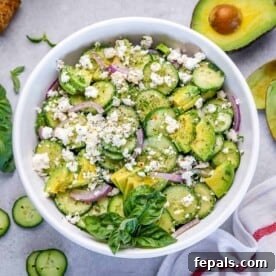 Top BBQ Side Dishes: 18+ Recipes for Summer Gatherings 11 a white round bowl with cucumber avocado and feta salad with basil garnish.