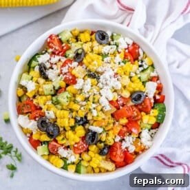 Top BBQ Side Dishes: 18+ Recipes for Summer Gatherings 6 corn salad in a white bowl with veggies and crumbled cheese.