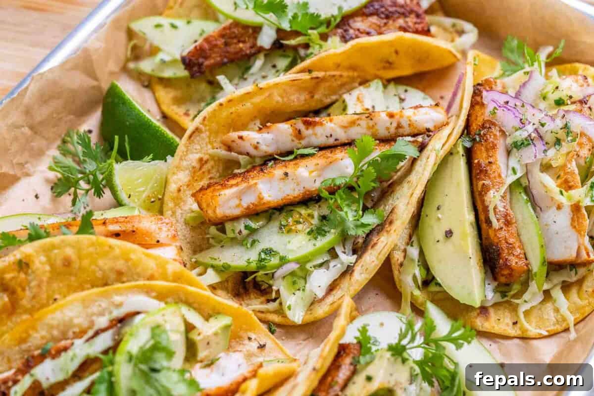 Crispy Mahi Mahi Tacos with Cilantro-Lime Crema 6 A close up of mahi mahi fish tacos with apple cabbage slaw.