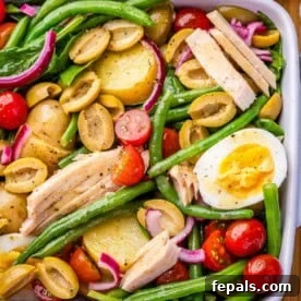 Nicoise salad in a white dish.