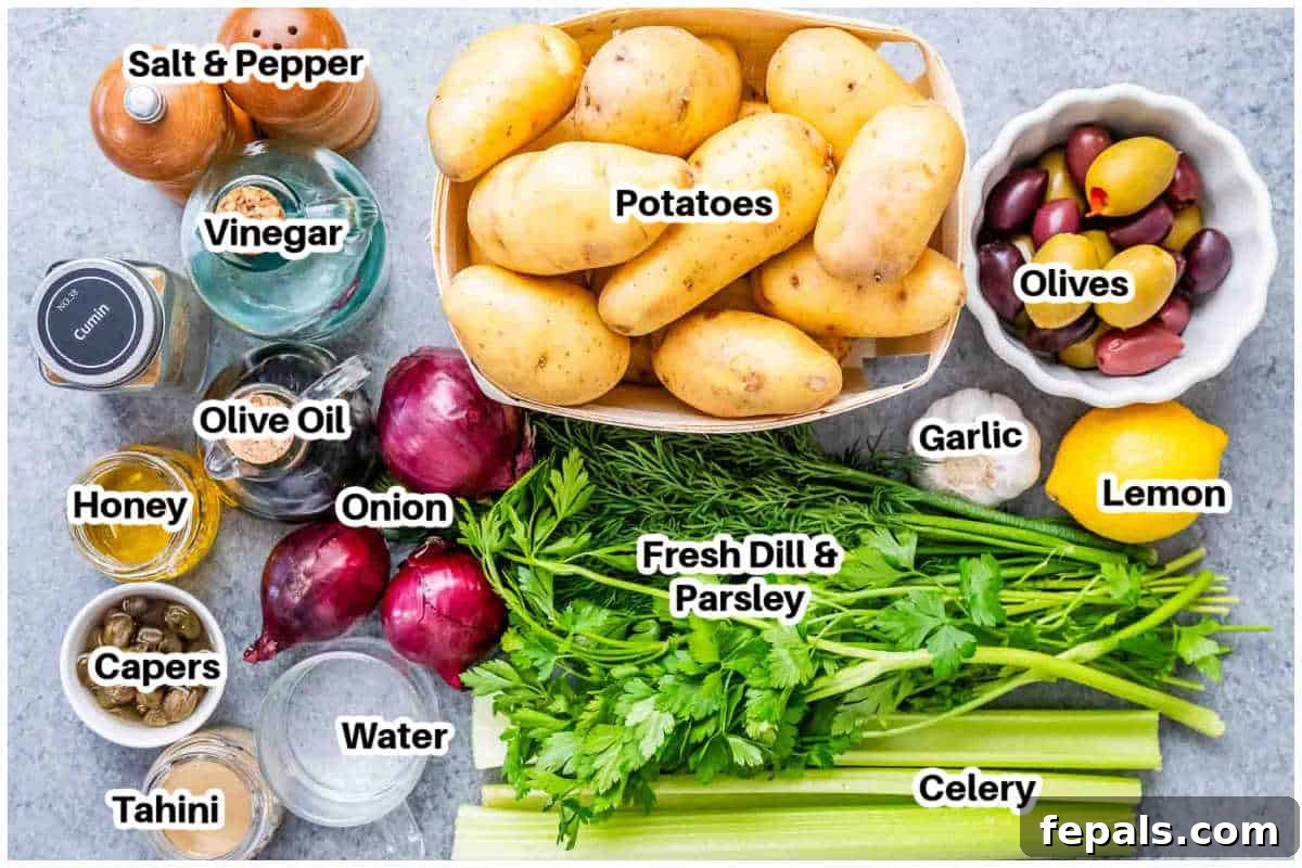 A display of fresh ingredients for smashed potato salad, including baby potatoes, olives, capers, celery, red onion, and herbs.
