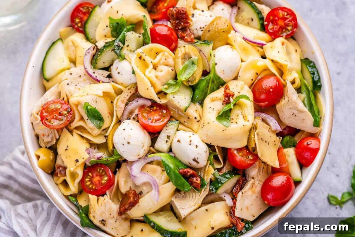 Zesty Italian Tortellini Toss 6 A close-up shot of the tortellini pasta salad in a bowl, highlighting the fresh ingredients.