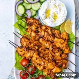 Fire Up the Flavor Grilled Chicken 11 Authentic chicken shish tawook skewers arranged neatly on a long white serving dish.