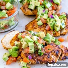 Fire Up the Flavor Grilled Chicken 12 A side view of sliced grilled chicken breast generously topped with fresh avocado salsa.