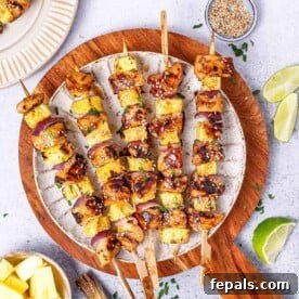 Fire Up the Flavor Grilled Chicken 6 Five beautifully glazed teriyaki chicken skewers presented on a round white plate.