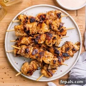 Fire Up the Flavor Grilled Chicken 7 Flavorful Bang Bang chicken skewers served on a plate, ready to eat.