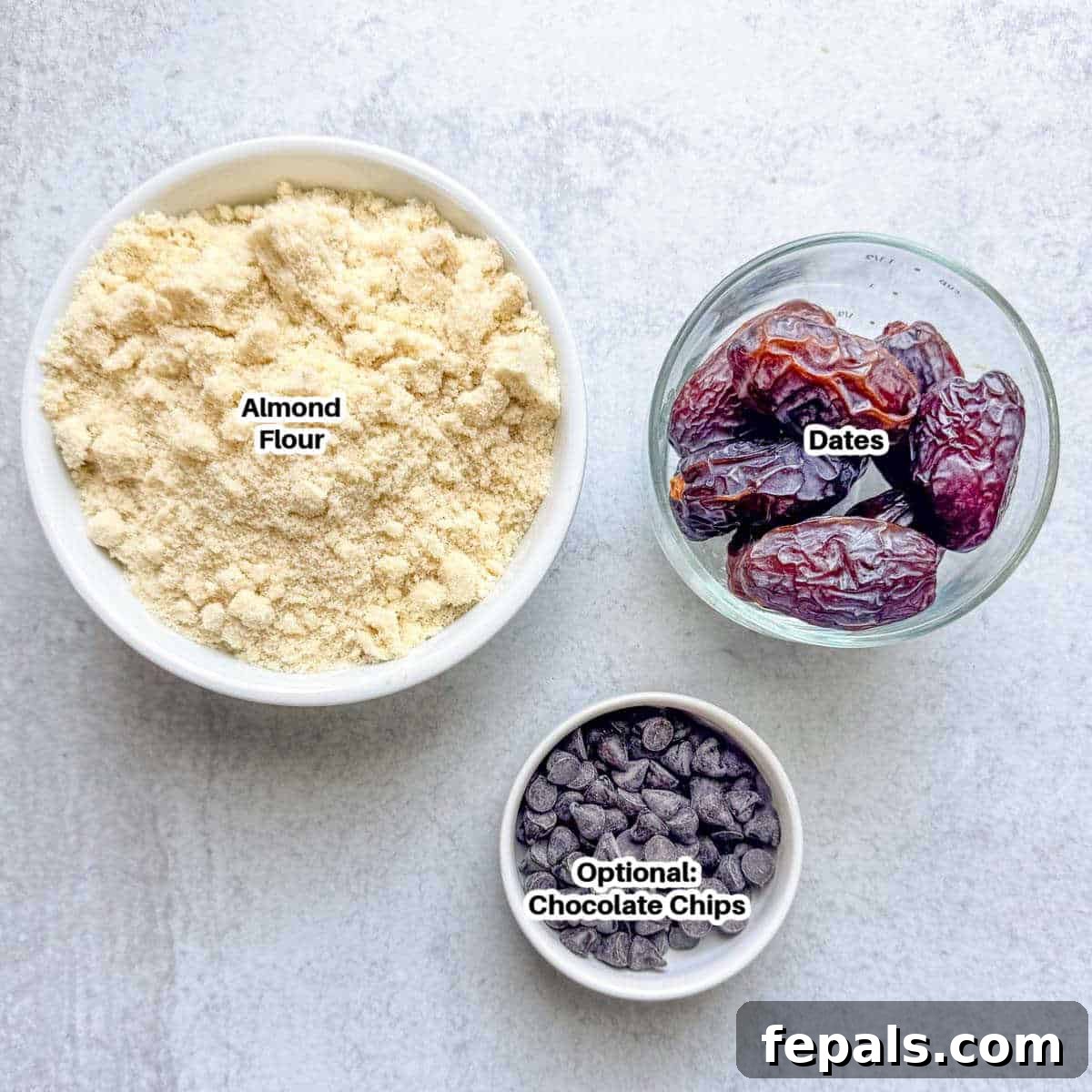 The two core ingredients for date cookies, medjool dates and almond flour, laid out with optional chocolate chips.