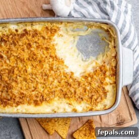 A baking dish filled with golden-brown and bubbly cheesy hash brown casserole, a classic comfort food.