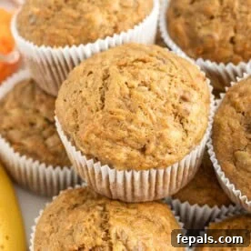 A stack of two healthy carrot banana muffins, showcasing their moist and tender crumb.