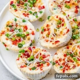 A close-up of copycat Starbucks egg white bites, showing their fluffy texture and specks of red bell pepper and green onion.