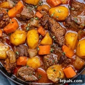 15-Minute Beef Dinners for Busy Weeknights 7 beef stew in a red and black skillet with potatoes and carrots.