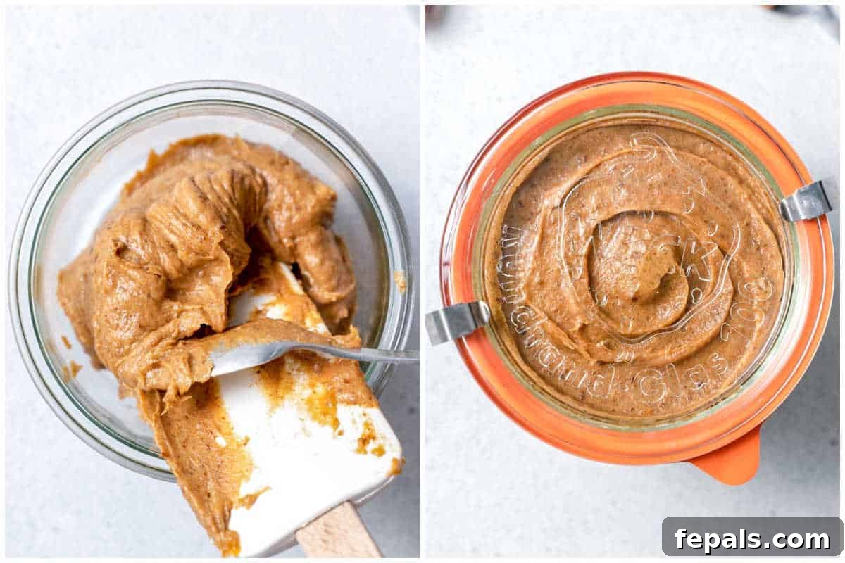The finished date paste being transferred from the food processor into a glass jar for storage.
