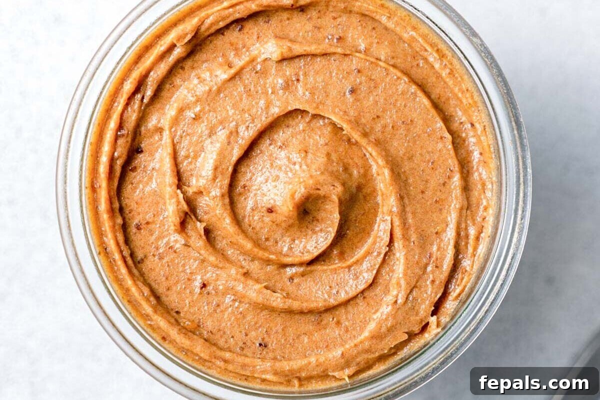 A close-up shot of a jar of homemade date paste, highlighting its smooth and rich texture.