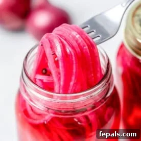 Quick Pickled Red Onions You’ll Prefer Over Store-Bought 9 pickled red onions in a jar.