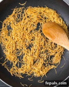 Classic Lebanese Vermicelli Rice 11 Vermicelli noodles being toasted to a golden brown in a saucepan.