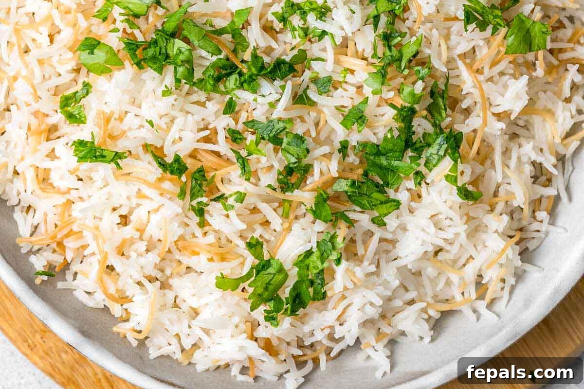 Classic Lebanese Vermicelli Rice 8 A final shot of the Lebanese rice in a white bowl, garnished with fresh chopped parsley.