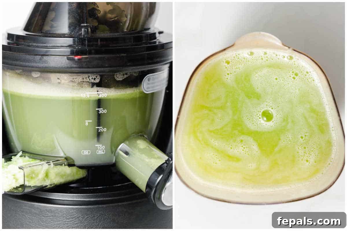 Freshly made celery juice being poured from a juicer into a glass mug.