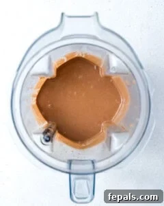 ingredients blended in a blender to make peanut butter chocolate protein shake.