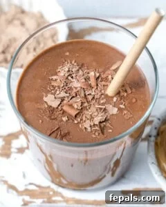 a cup with a straw that has chocolate peanut butter smoothie.