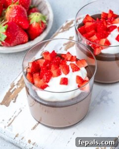The final cottage cheese chocolate pudding served in a cup, garnished with whipped cream and fresh strawberries.