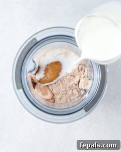 ingredients for protein chocolate pudding being placed into a blender.