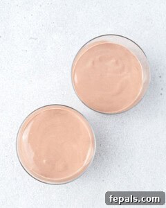 The finished chocolate pudding divided evenly between two glass serving cups.