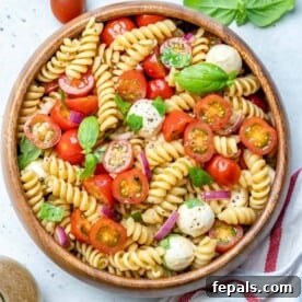 Caprese pasta salad topped with basil