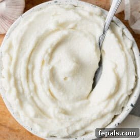 garlic sauce dip with a spoon