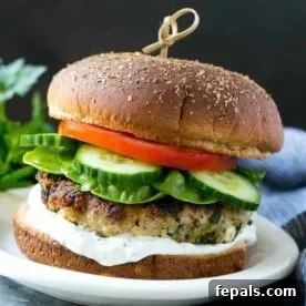 one turkey feta burger with lettuce, cucumber, tomato, and tzatziki sauce