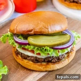A hamburger on a wooden board.
