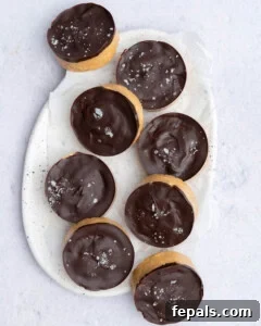 No-Bake Peanut Butter Oat Cups Recipe 15 peanut butter protein oat cups placed on a plate to be stored.