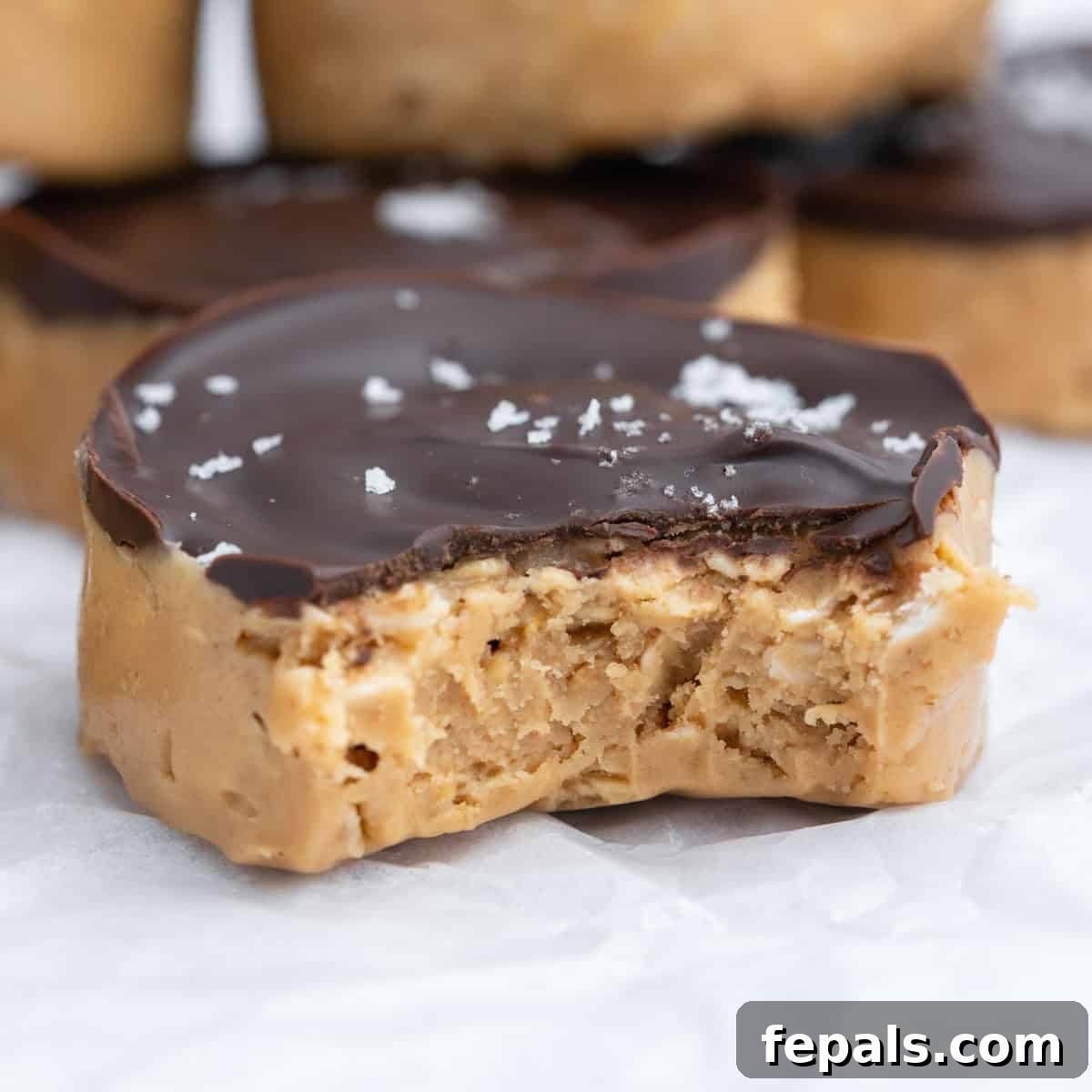 No-Bake Peanut Butter Oat Cups Recipe 8 a bite taken off a peanut butter oat cups.